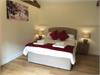 Beautiful Master Bedroom with vaulted ceiling and beams. Window looking out onto the private garden/court yard.