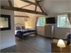 Beautiful spacious  Master bedroom with Kingsize bed,  43” t.v, en-suite shower room,  original beams and vaulted ceiling,  windows looking out to the mature garden/courtyard.
