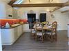 Modern spacious Kitchen/Diner with vaulted ceiling and exposed beams.