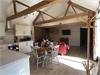 Open plan kitchen/diner and Lounge with vaulted ceilings, exposed beams and brick and flint walls.  Central wood burner.  Large window looking out to enclosed private courtyard.