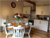 Beautiful open Plan Kitchen/Diner/Lounge with vaulted ceiling and beams.  Original exposed Brick & Flint walls.  Large window looking out onto private court yard.