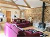 Lounge area with original Brick & Flint exposed wall and beautiful vaulted ceiling with beams and a central wood burner. Patio door leading out to private court yard.